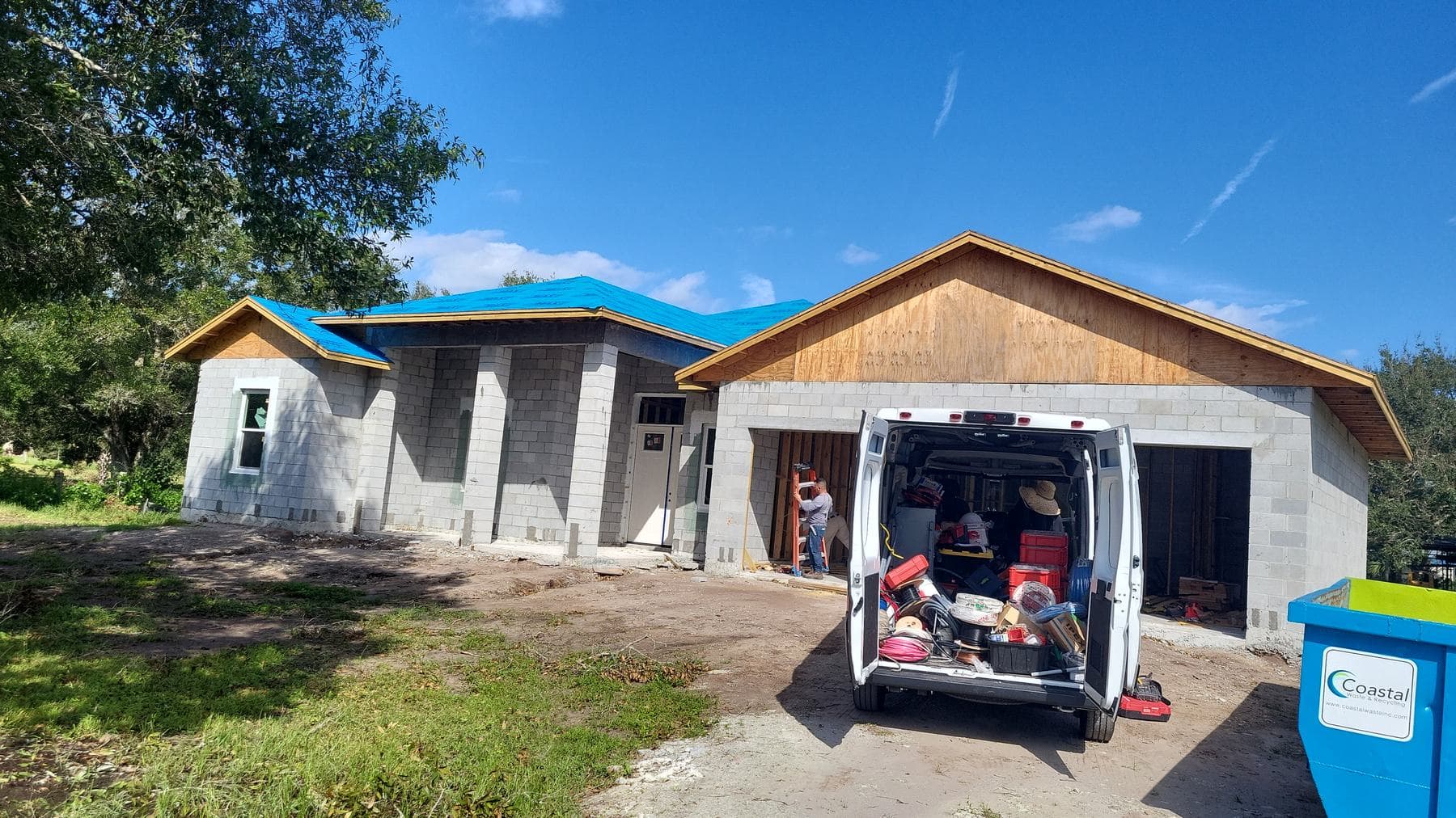 Crane setting roof trusses on a Covenant Builders home under construction on the Treasure Coast